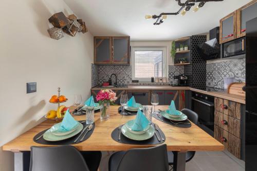 a kitchen with a wooden table with blue hats on it at Deluxe House Maj in Brežice