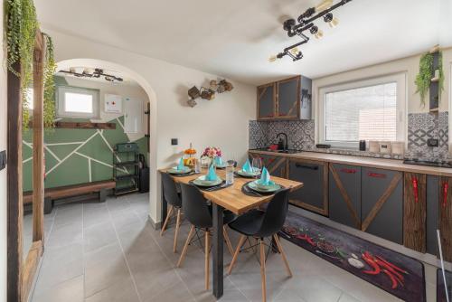 Il comprend une cuisine avec une table et des chaises en bois. dans l'établissement Deluxe House Maj, à Brežice