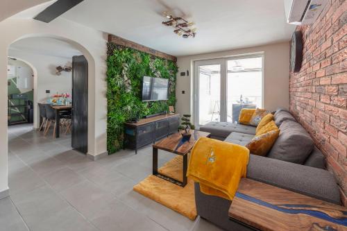 a living room with a couch and a tv at Deluxe House Maj in Brežice