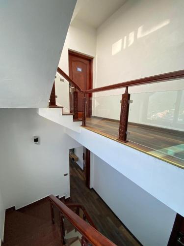 an empty room with stairs and a window at Hiệp Gà Villa Tam Đảo - Venuestay in Tam Ðảo