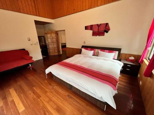 a bedroom with a large bed and a red couch at Raisinay in Nanzhuang