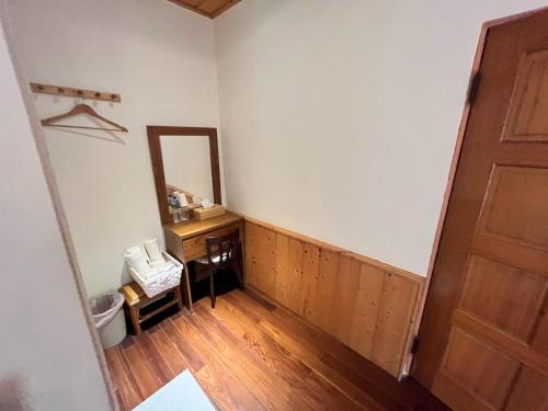 an empty room with a door and a mirror at Raisinay in Nanzhuang