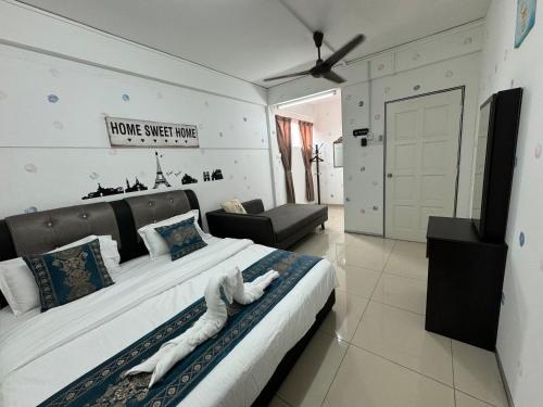 a bedroom with a large bed with towels on it at Dsney Boutique Hotel in Melaka