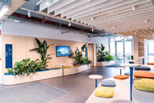 an office with plants on the walls and tables at Ripamonti Milan Porta Romana Cosy vibes and modern rooms right around the city centre in Milan