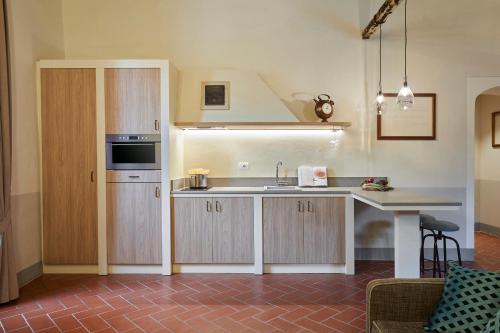 a kitchen with a sink and a counter top at Tenuta di Artimino member of Meliá Collection Wine Resort in Artimino