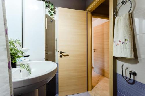 a bathroom with a white sink and a shower at Urban Living, Minicasa Nomad - Kalamata's Hideaway in Akovítika