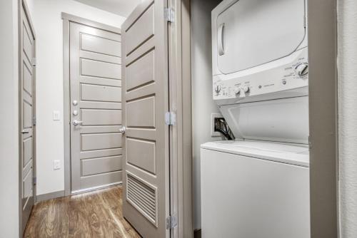 a laundry room with a washer and dryer at Ballard 1BR w Gym Rooftop Deck nr shopping SEA-268 in Seattle