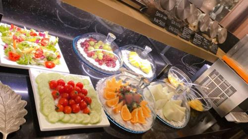a buffet with many different types of fruits and vegetables at Hotel Mythos in Milan