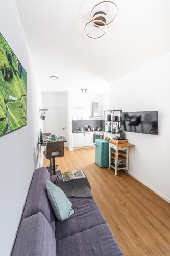 a living room with a couch and a desk at Apartment Weingut Dr Hermann I in Erden