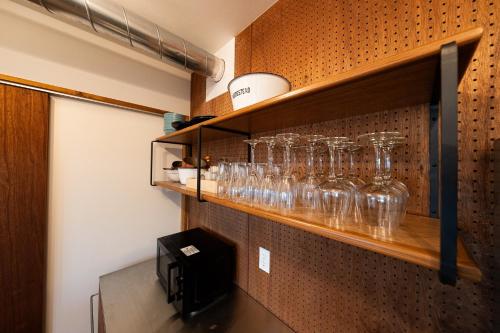 a shelf filled with glasses on a wall at theView 南房総 in Ichibu