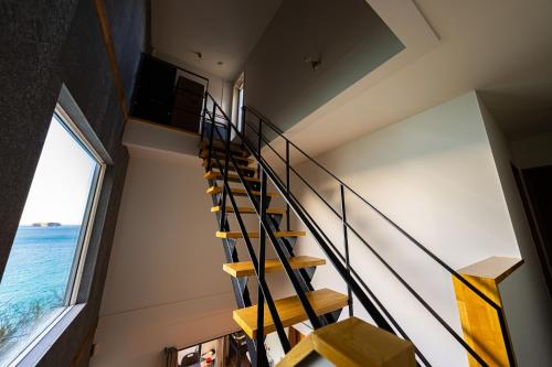 a staircase in a house with a view of the ocean at theView 南房総 in Ichibu