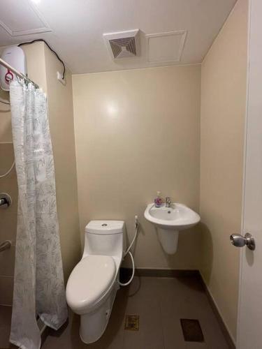 a bathroom with a toilet and a sink at * *H2 Modern City Condo in Iloilo City