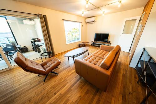 a living room with a couch and a table at theView 南房総 in Ichibu