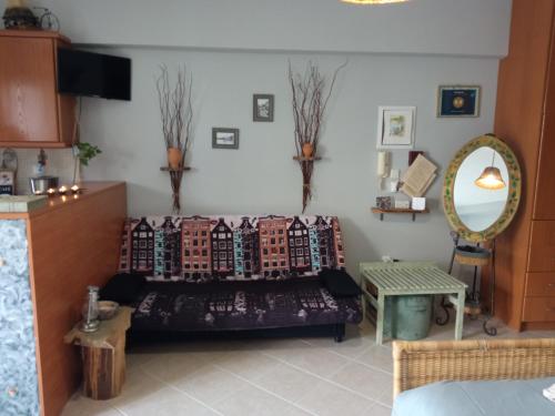 a living room with a couch and a mirror at Nix Nax Kalamata in Kalamata