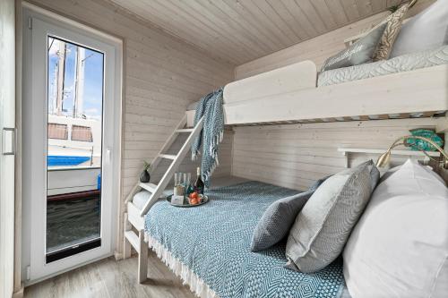 1 dormitorio con litera y ventana en Blåbær en Egernsund