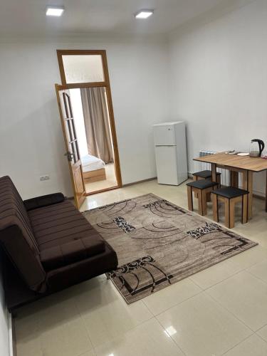 a living room with a couch and a table at Mtour Apartment in Gyumri
