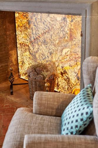 a living room with a couch and a map on the wall at Tenuta di Artimino member of Meliá Collection Wine Resort in Artimino