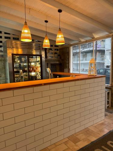 a bar in a restaurant with pendant lights at Isalos Suites in Néa Péramos