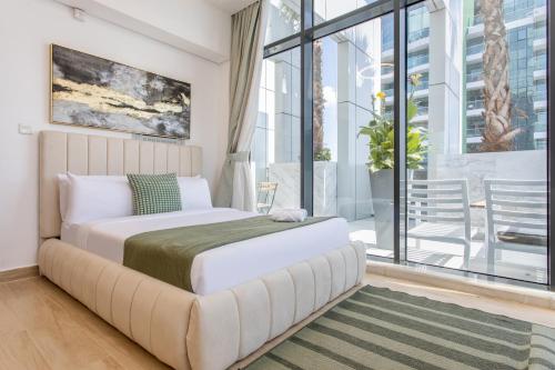 a bedroom with a large bed and a large window at Holiday Studio In JVC 2302, Dubai in Dubai