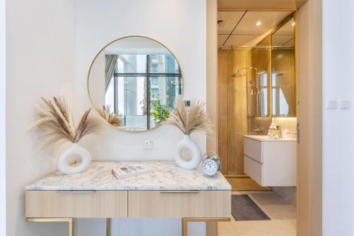 a bathroom with a sink and a mirror at Holiday Studio In JVC 2302, Dubai in Dubai