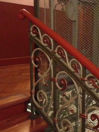 a metal fence with a bench next to a staircase at Apartmenthotel Quartier M in Leipzig
