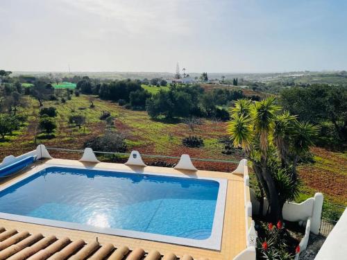a swimming pool on top of a house at Self-contained floor of Quinta / Villa in Guia