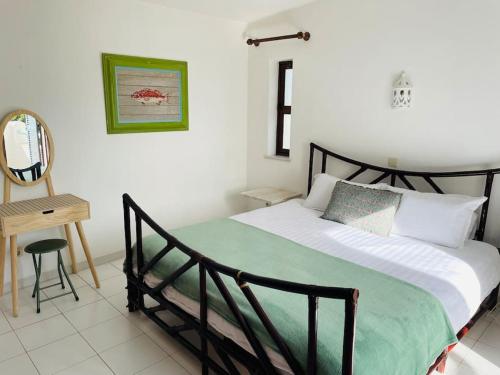 a bedroom with a bed and a table and a mirror at Self-contained floor of Quinta / Villa in Guia