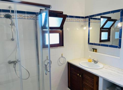 a bathroom with a sink and a shower at Self-contained floor of Quinta / Villa in Guia