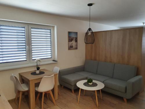 a living room with a couch and a table at DomirexGroup Apartments in Lučenec