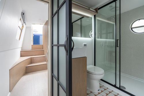 a bathroom with a toilet and a walk in shower at Serenity in the Heart of London in London