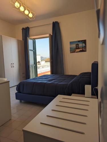 a hotel room with a bed and a balcony at Villa Carosino in Vietri sul Mare