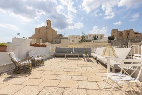 a patio with chairs and tables on a roof at La Loggetta in Ugento