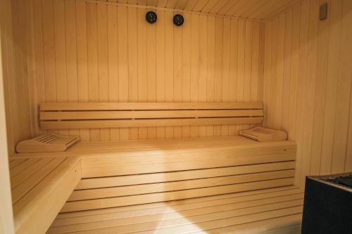 a wooden sauna with a wooden bench in it at Belambra Clubs Les Saisies - Les Embrunes - Ski pass included in Villard-sur-Doron