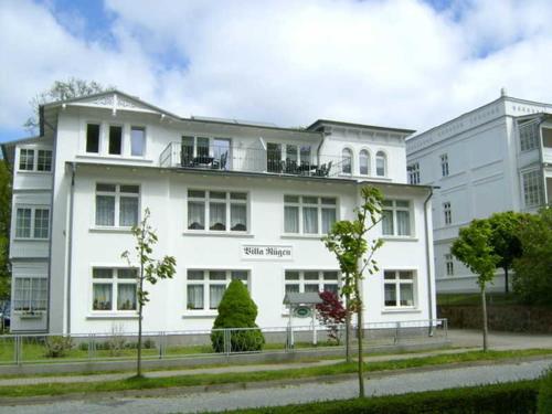 a white building with trees in front of it at "Villa Rügen" - 300 m zum Strand in Binz