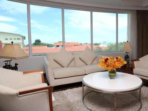 a living room with a couch and a table at Plaza Sutera Biru Hotel in Kuala Belait