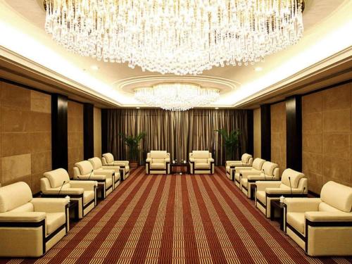 a conference room with chairs and a chandelier at Zibo Blue Horizon International Hotel in Zibo