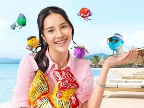 a woman sitting on the beach with birds in the air at Hotel Bintang Tawangmangu in Tawangmangu