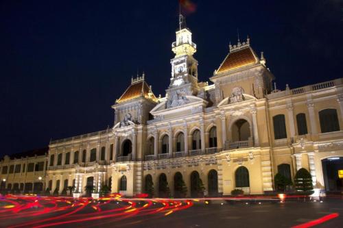 a large building with a clock tower at night at Au Lac 2 Hotel in Ho Chi Minh City