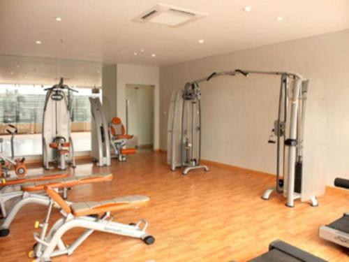 a gym with several exercise equipment in a room at Amalia Hotel Lampung in Lampung