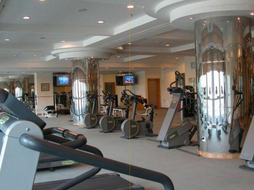 a gym with a bunch of tread machines in it at Changsha ST-Tropez Hotel in Xingsha