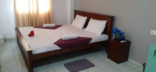 a bedroom with a large bed with two pillows at Ocean Villa in Panadura