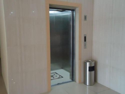 a glass door to a shower in a room at Hotel Makmur in Karanganyar