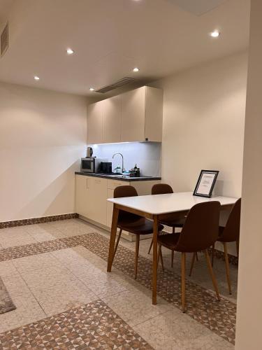 a kitchen with a table and chairs in a room at CATHEDRAL Old Town Suites in Vilnius