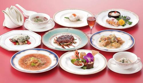 a group of plates of food on a red table at Oita Century Hotel in Oita
