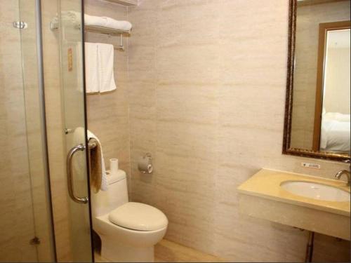 a bathroom with a toilet and a sink and a mirror at Super 8 Hotel Xiamen Railway Station in Xiamen