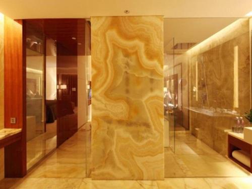 a bathroom with a shower and a glass wall at Hotel Leader Changsha in Yangtianhu
