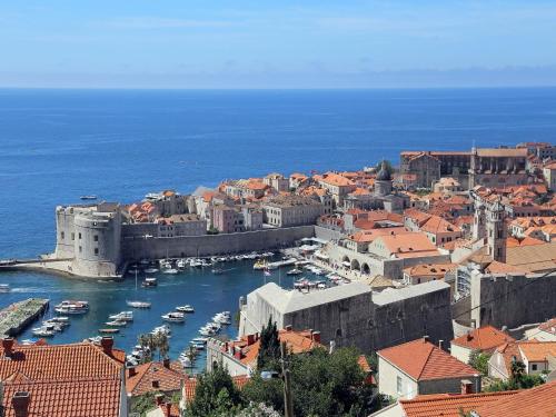 a view of a city with boats in a harbor at Isaura Apartments in Dubrovnik