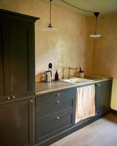 a kitchen with a sink and a counter top at Rallarhustruns in Hässleholm