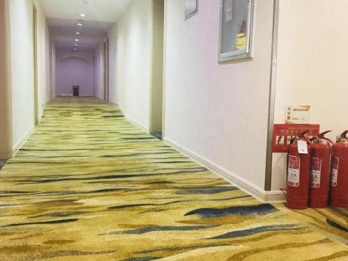 a hallway with a carpeted floor and fire hydrants at Super 8 Hotel Jinan Railway Station Square in Jinan