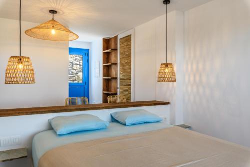 a bedroom with two blue pillows on a bed at Emerald Bay 4BR with pool by Lia Beach in Mikonos